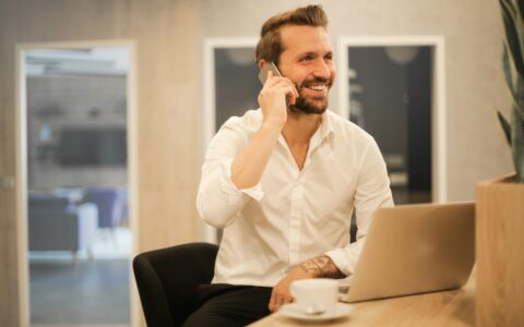 man using smartphone on chair